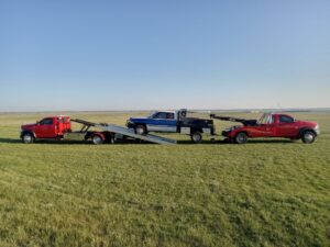 Flatbed tow operation transporting vehicles safely